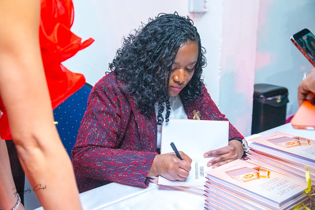 The author signing copies of her book