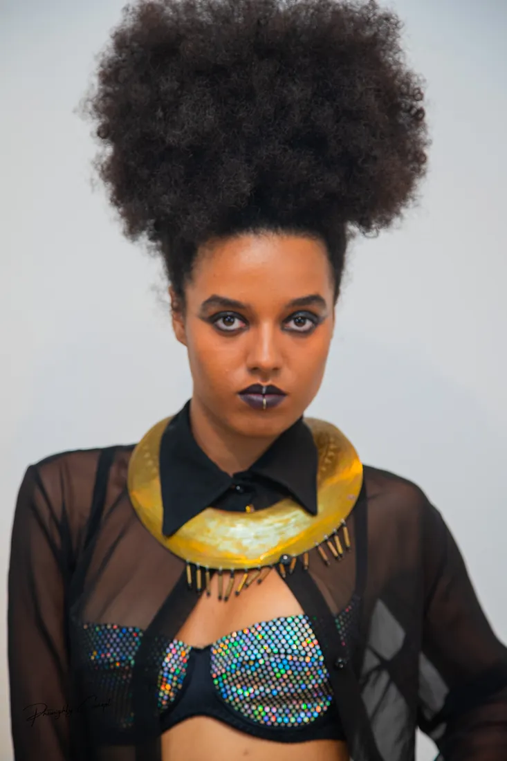 Gold collar, dark lips and a direct gaze