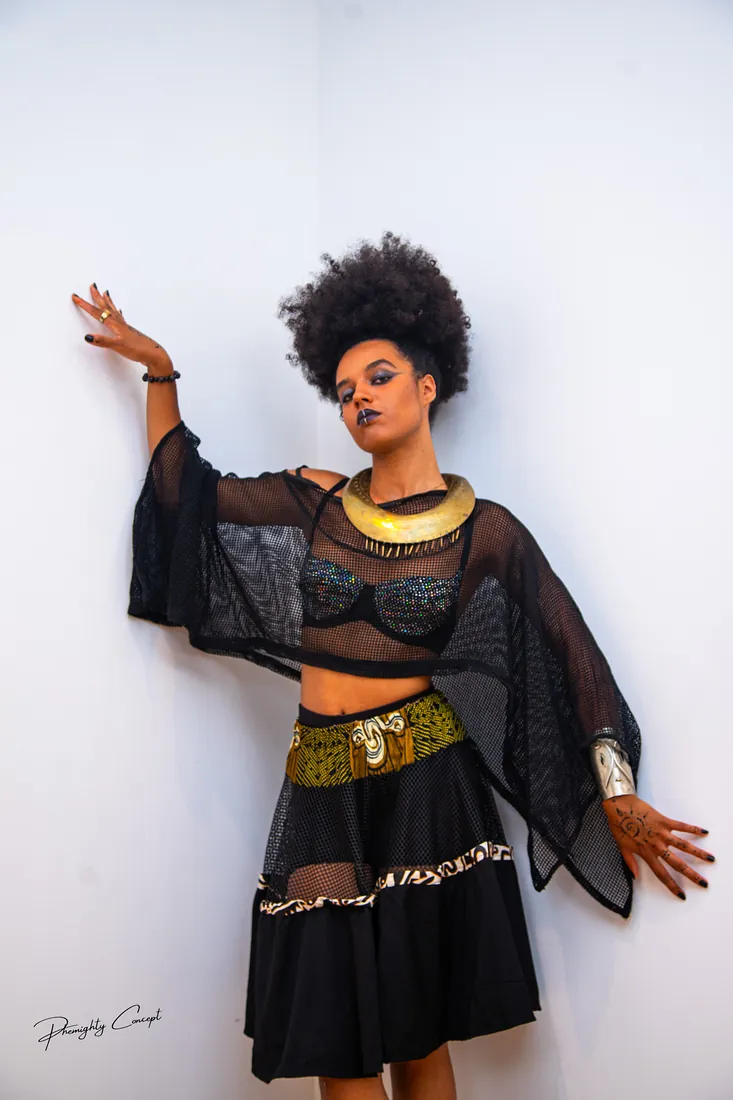 Full length: sheer sleeves and a brass belt